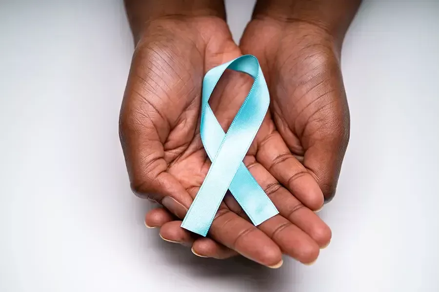 Hands holding ribbon for cervical cancer awareness