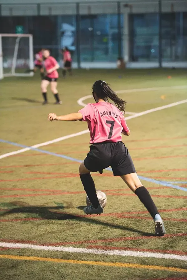 girl playing soccer in a game