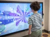 Child playing with the interactive screen in the lobby