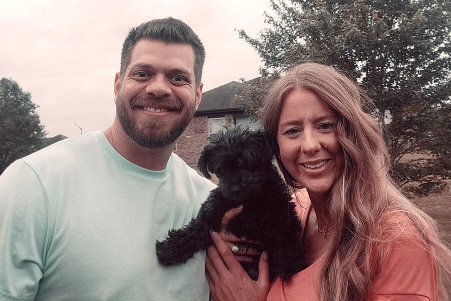 Rob Presson, a certified registered nurse practitioner with the Heart Center at Huntsville Hospital, and his wife, Amanda, cuddle with Pebbles, an 11-year-old Yorkshire Terrier they are fostering while her dog mom awaits a lifesaving heart procedure.