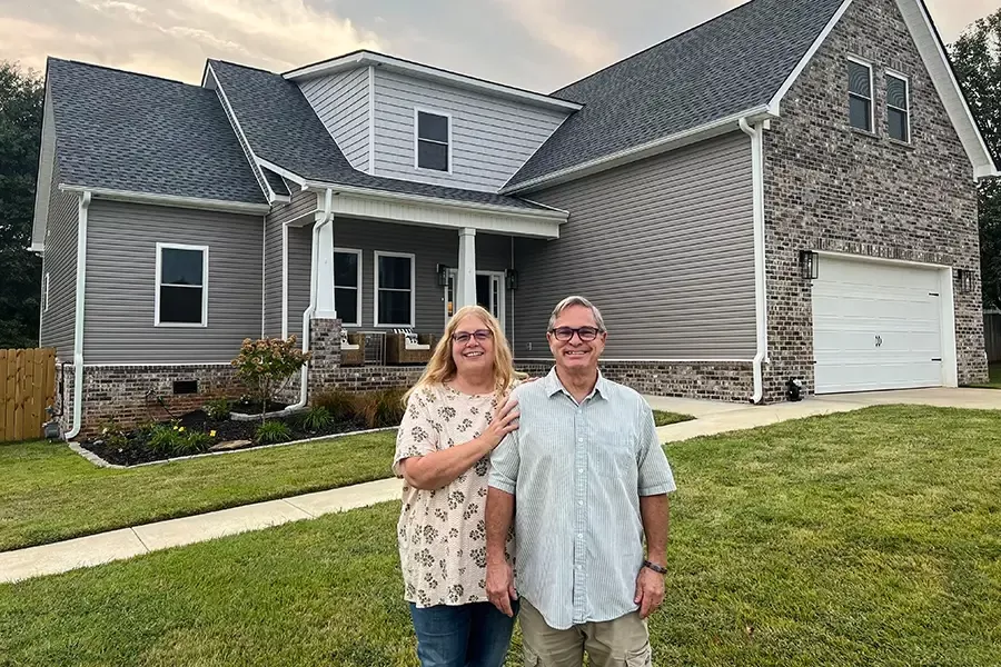 Joe and Teresa Robison stand in front of their new home in Madison.