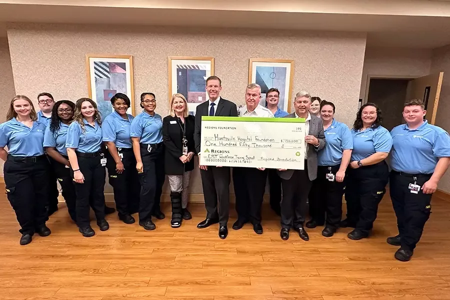 New graduates of the HEMSI EMS Academy Program and other leaders take a photo with a check from The Regions Foundation, who funded a grant for the EMS training.